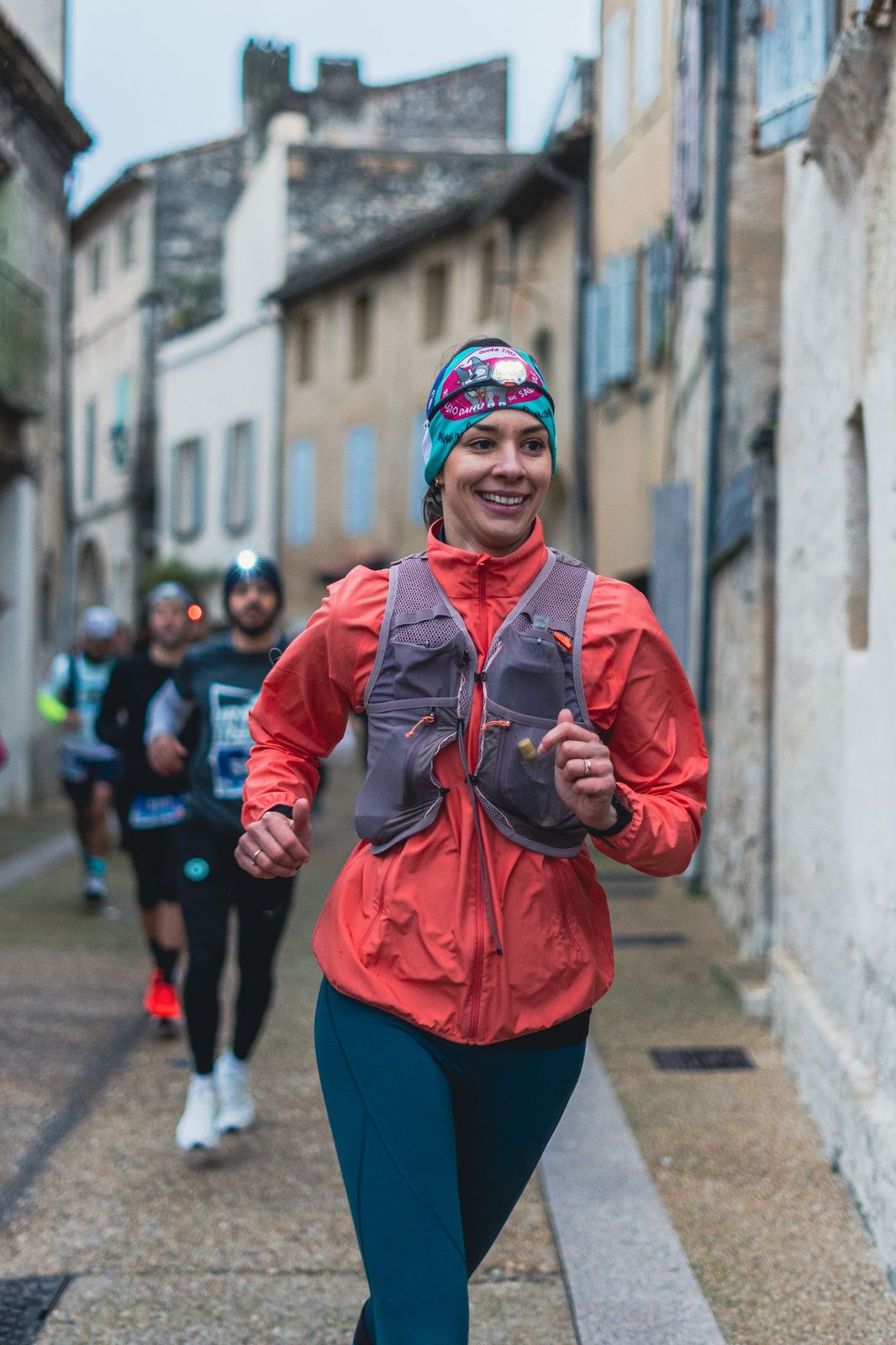 Coureuse souriante dans une ruelle du village