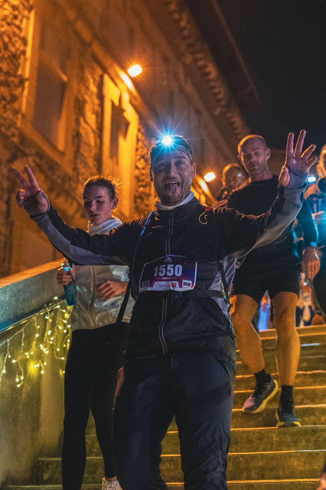 Coureurs bras levés dans un escalier